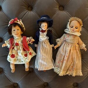 Vintage Doll Trio with Red, Blue, and Cream Outfits